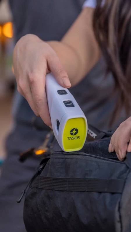 Woman putting TASER Bolt 2 into bag